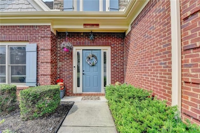 Entrance to property featuring brick siding
