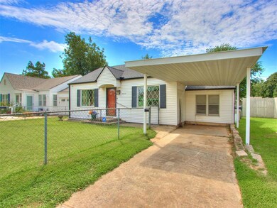 Ranch-style house featuring a front lawn and a car