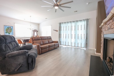 Living area featuring visible vents, light wood-ty