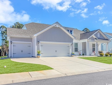 View of front of house featuring a shingled roof, 