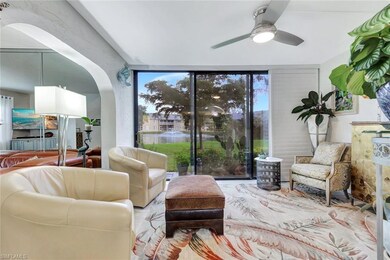 Living area featuring arched walkways, a wall of w