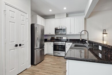 The Kitchen features stainless steel appliances (Microwave, Dishwasher & Oven were replaced in 2022), newly painted white cabinets & a spacious pantry.