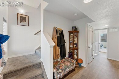 Stairs with hardwood / wood-style floors and a tex