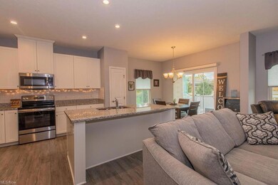 Kitchen with backsplash, wood-type flooring, appli