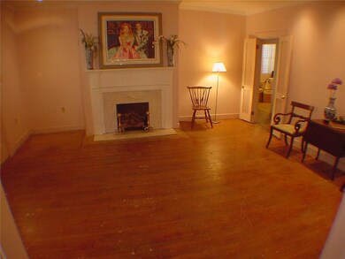Front parlor has wood floors & pretty fireplace se