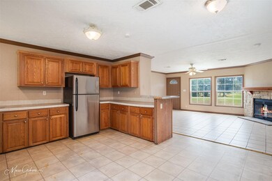 Kitchen featuring a fireplace, stainless steel ref