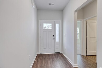 Foyer featuring dark wood-style floors and baseboa