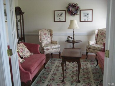 Formal living room has French doors, could also be