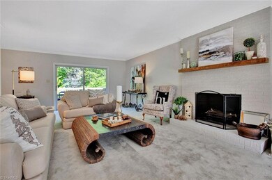 Living Room: Room features include carpet flooring, fresh new paint, a sliding door to the rear deck, two windows for natural lighting, decorative crown molding, recessed lights and the wood burning fireplace (have it inspected before using).