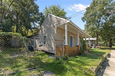 View of property exterior with covered porch and a central air condition unit