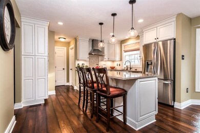 Extraordinary kitchen that was installed in 2016. Custom wood cabinetry, quartz countertops, ceramic backsplash and stainless appliances ( LG French door refrigerator, Bosch 5 burner gas range, Kitchen Aid dishwasher). Adjacent to the kitchen is the 