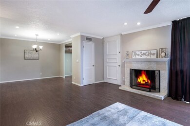Living room view to dining area and kitchen entrance.