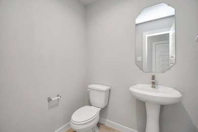 This charming half bathroom, boasting a sophistica