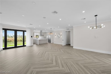 Unfurnished living room featuring baseboards, orna