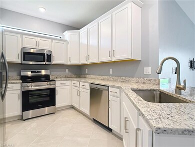 Kitchen featuring white cabinetry, kitchen peninsu