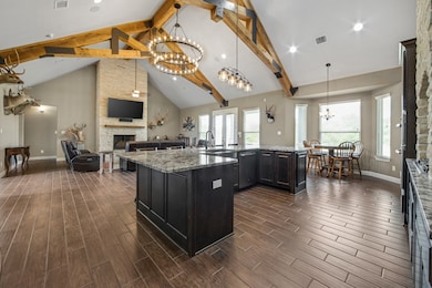 Floor to ceiling stone fireplace in living room.