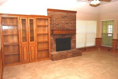 Spacious family room showing fireplace and built-i