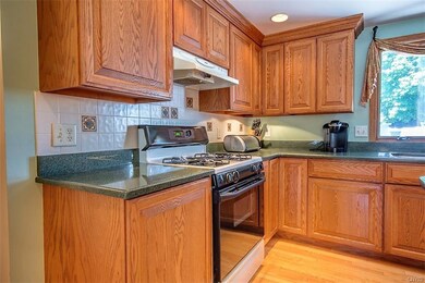 A gas range and more cabinets with pull-out shelvi