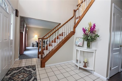 Open 2 story foyer looking left into Living room