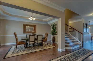 The formal dining room seamlessly transitions to the more casual family living area beyond.
