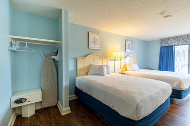 Bedroom featuring a textured ceiling and dark hard
