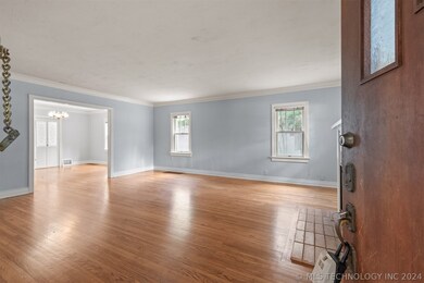 Gleaming original hardwood floors welcome you in a