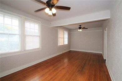 Spacious living and dining areas with original har
