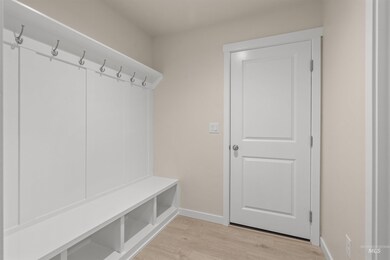 Mudroom featuring baseboards and light wood-type flooring
