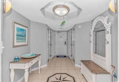 Entryway featuring light tile patterned floors, a 