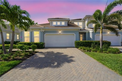 View of front of property with a tile roof, decorative driveway, stucco siding, and a garage