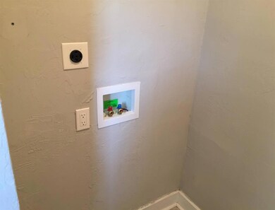 Unit B Laundry room featuring washer hookup