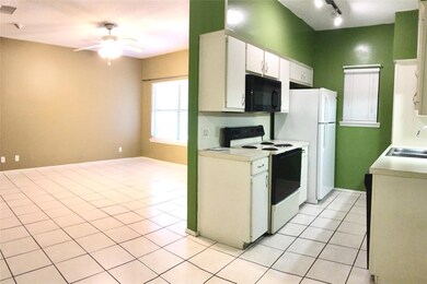 Kitchen with light countertops, a sink, black mic