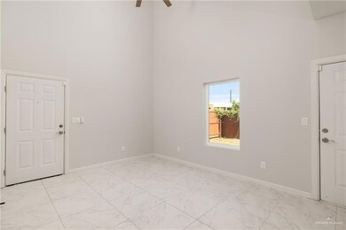 Unfurnished room with a high ceiling, light marble finish floors, and a ceiling fan