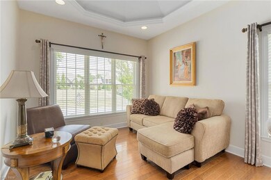 COZY LIVING ROOM WITH TRAY CEILING AND LARGE WINDO