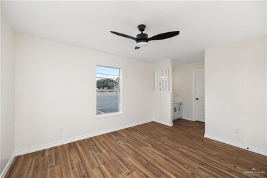 Empty room with dark hardwood / wood-style flooring and ceiling fan