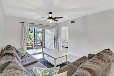 Living area featuring a ceiling fan, baseboards, and light wood finished floors