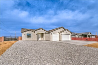 Ranch-style house with driveway, stucco siding, fe