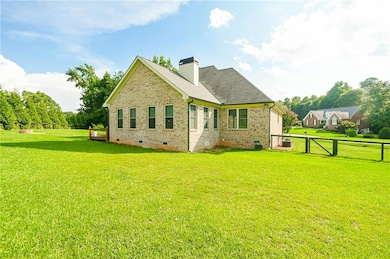 Back of property featuring a yard