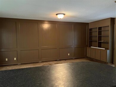 Family room with built in bookcases, opposite kitc