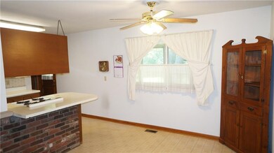 Dining area.  Corner cabinet stays. Plenty of space for bar stools