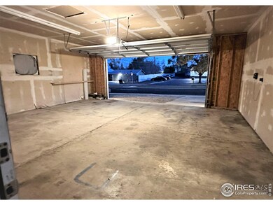Brand new garage door in large lit garage.