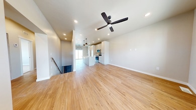 Unfurnished living room with light wood finished floors, recessed lighting, and a ceiling fan