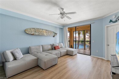 Living room featuring ceiling fan, baseboards, cro