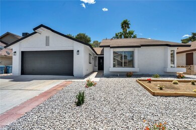 Ranch-style house with stucco siding, an attached