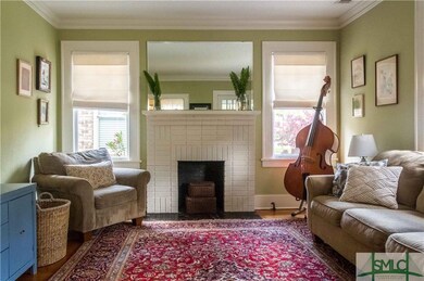 Light-filled living room has cozy fireplace nestle