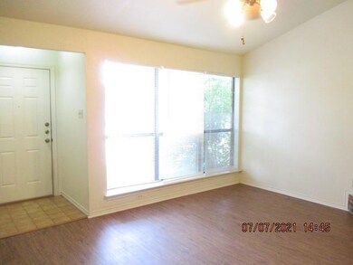 Enter into a spacious living room with tall ceilin