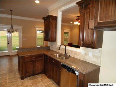 Kitchen has custom cabinets, stainless appliances, granite counter tops, tile floors, recessed lighting, tile back splash and pantry.