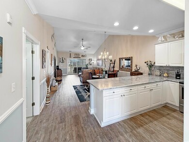 Kitchen featuring wood finished floors, white cabi