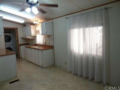 Country kitchen and view of laundry room. Rooms ar