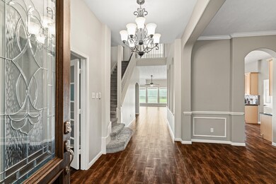 It will be love at first sight! Open the door to elegant finishes from the front door to the back. You'll find gorgeous wood-look tile floors, fresh neutral paint, soaring ceilings with elegant lighting and fans, and fabulous natural light.